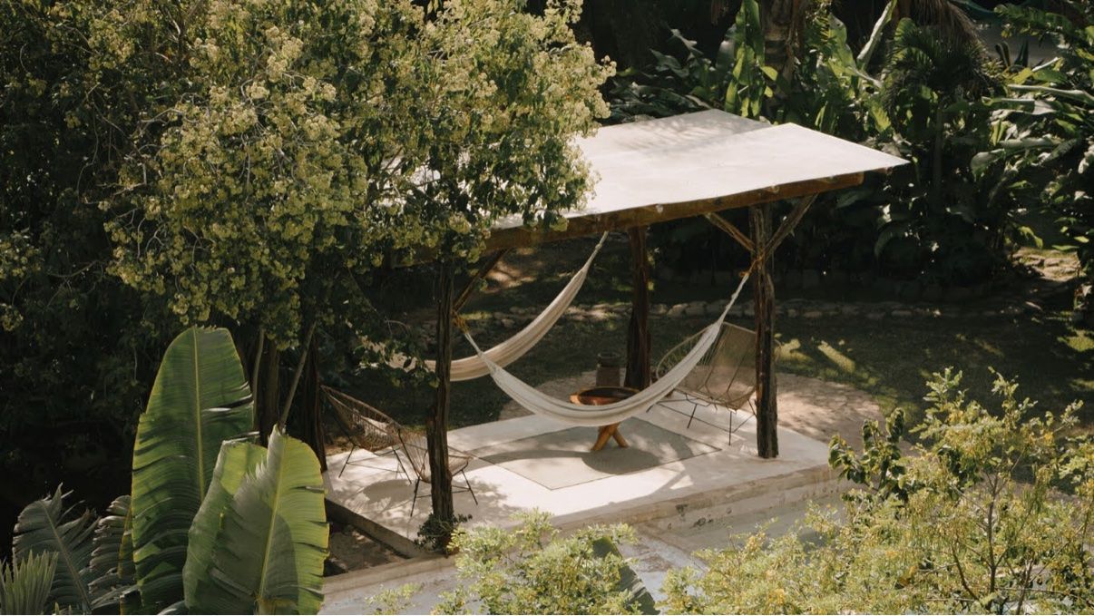 Hammocks under a pergola in the jungle garden