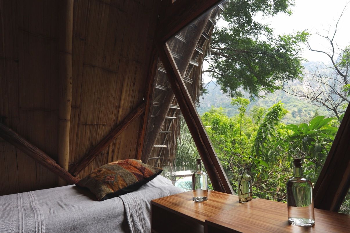 Inside a safari tent, bed looking out to the jungle